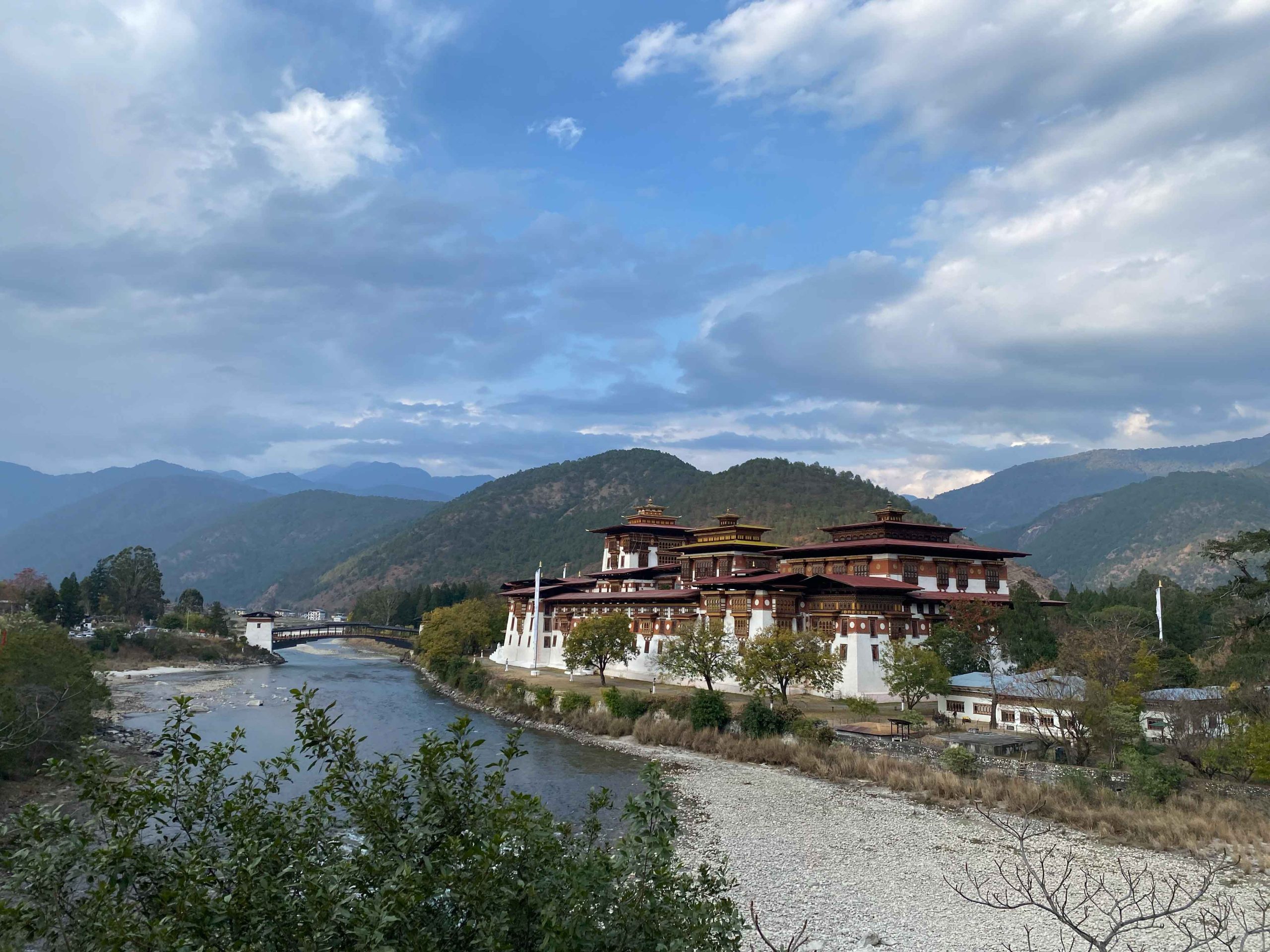 Punakha Dzong at the confluence of two rivers, backed by forested hills